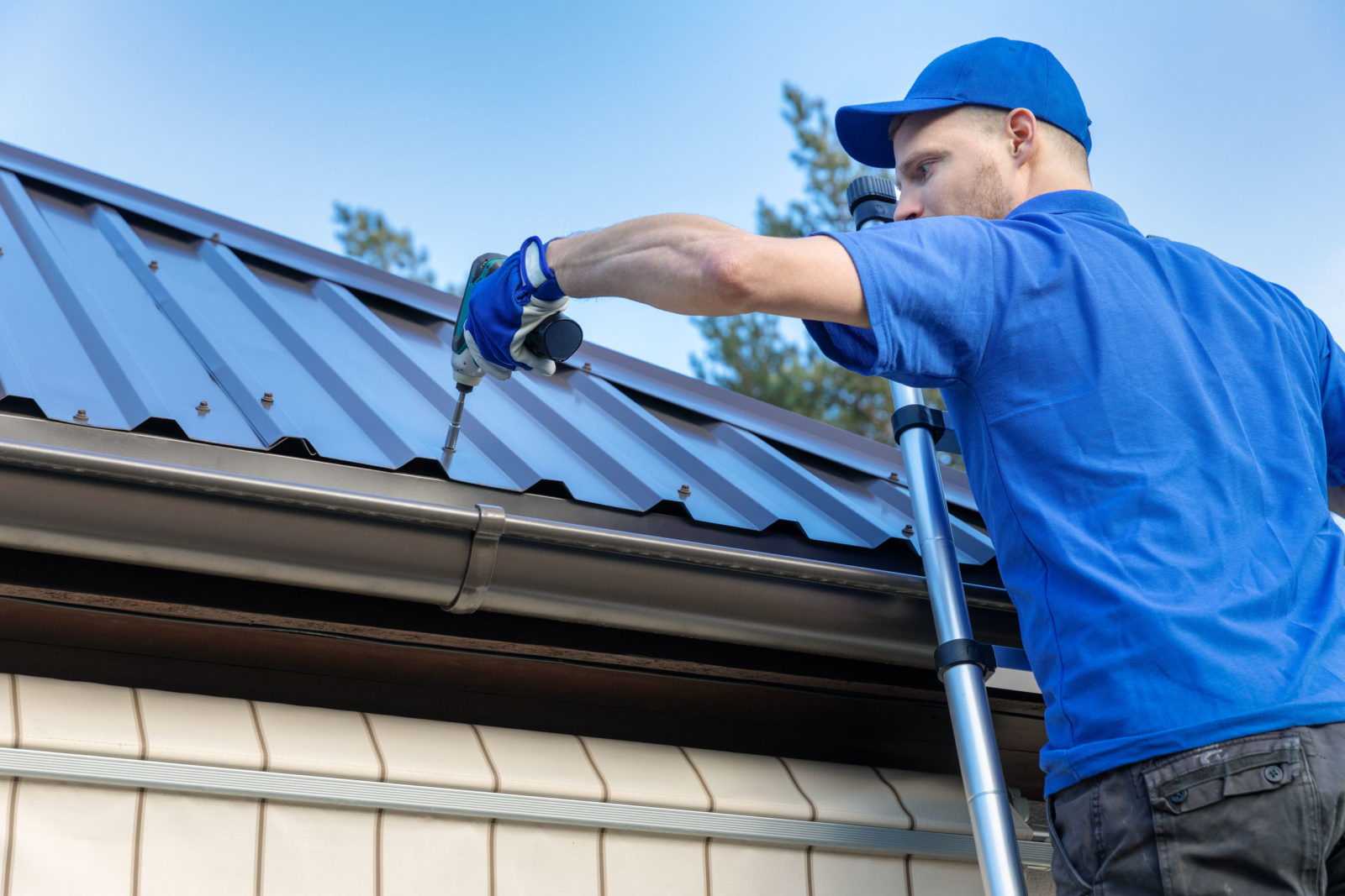 Gutter and drip edge secured along a metal roof in Central Florida