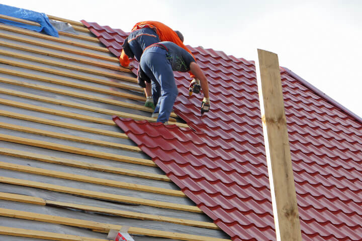 Assure-U Roofing crew installing tile on a steep Central Florida re-roofing project